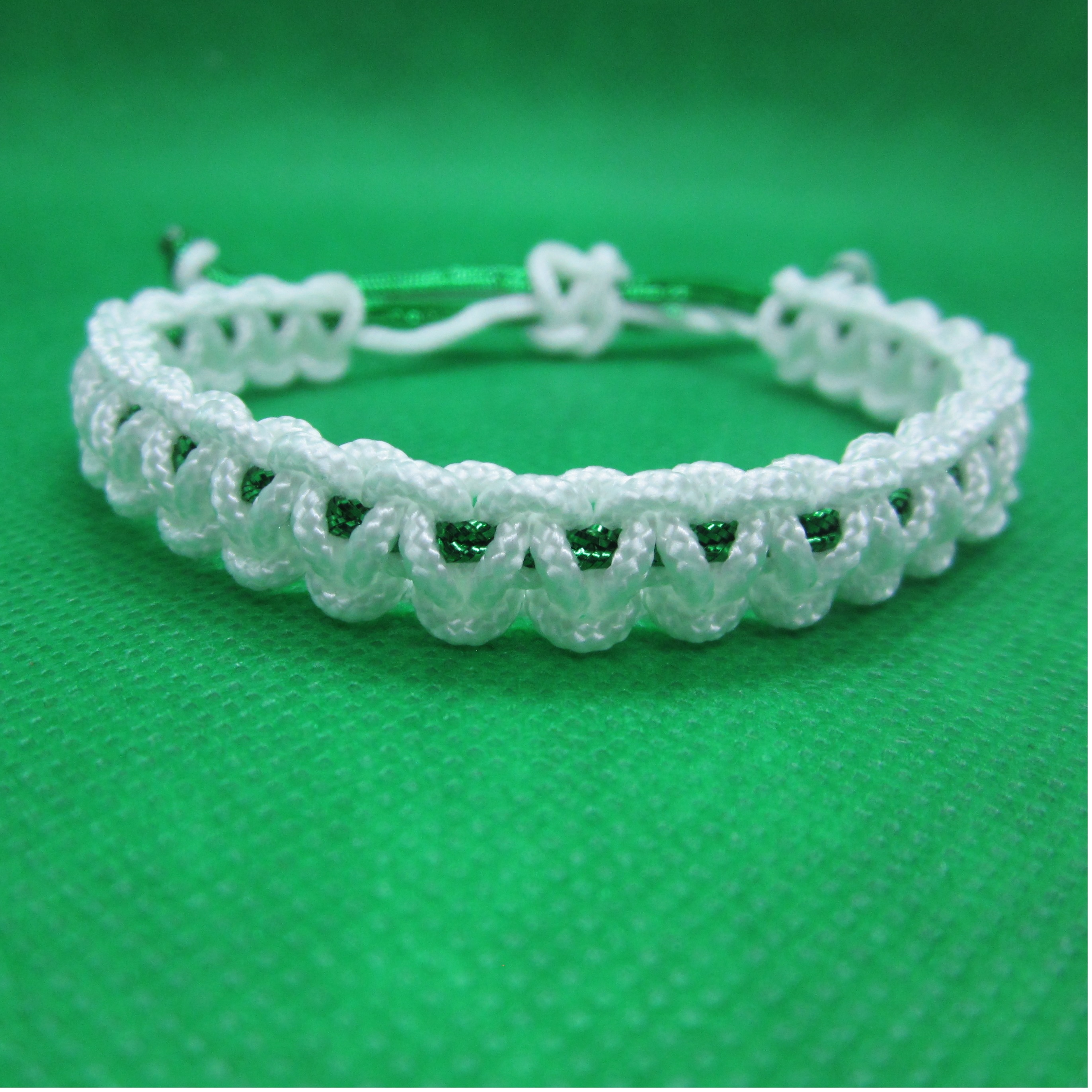 Bracelet white with sparkle green cord